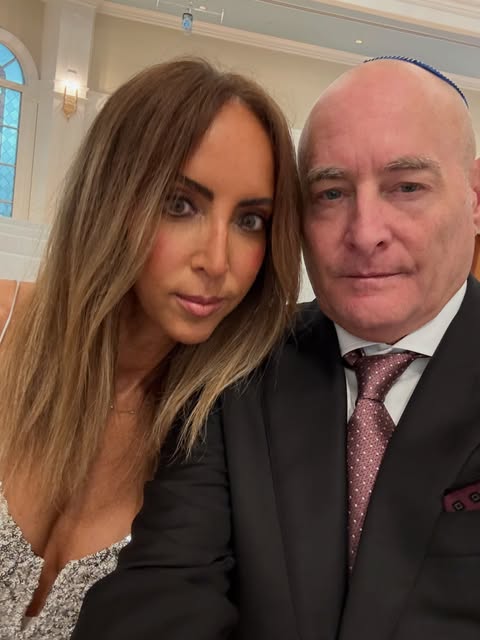 Mara and her husband dressed for a wedding